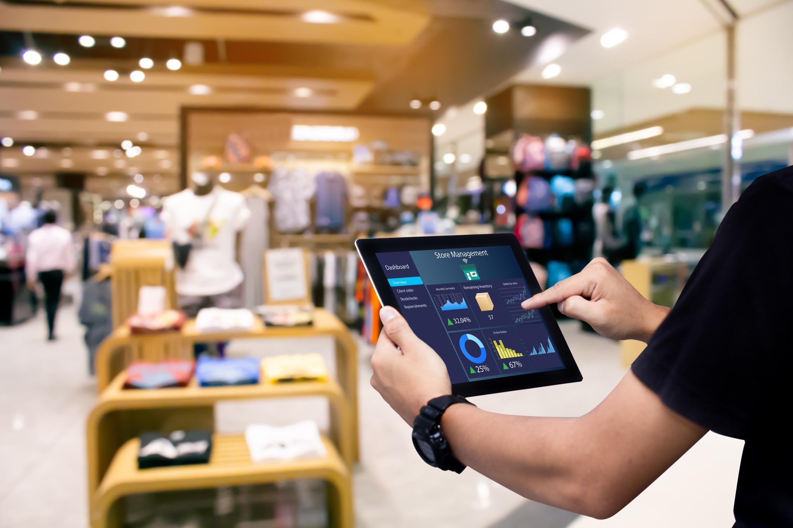 Close-up of a person using a tablet with technology-driven solutions displayed on screen.