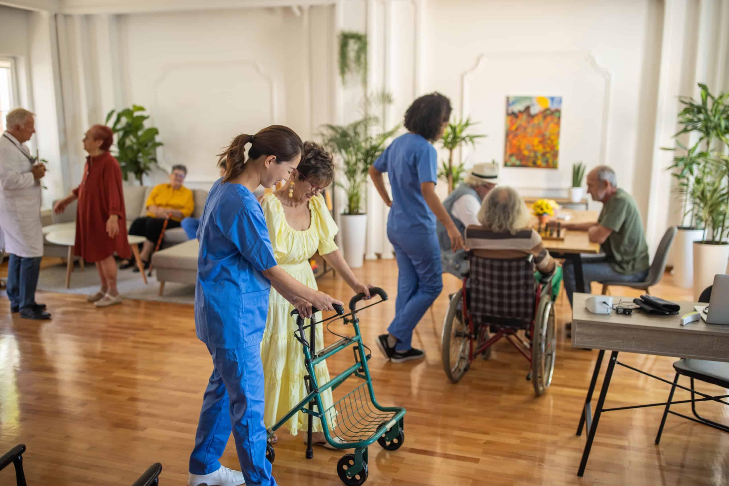 Healthcare professionals in a care environment helping elderly individuals, showcasing compassionate aged care services.